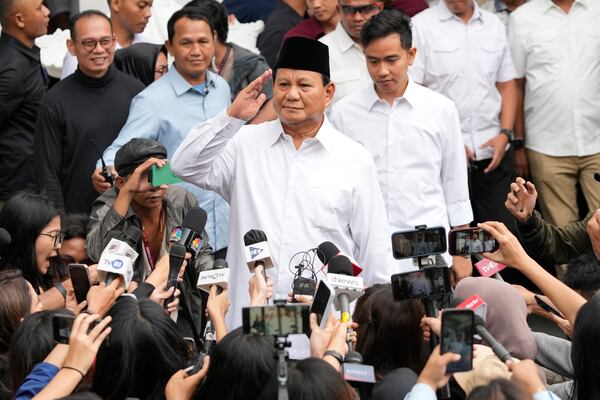 FILE - Indonesian Defense Minister and President-elect Prabowo Subianto salutes journalists in Jakarta, Indonesia, Wednesday, April 24, 2024. (AP Photo/Achmad Ibrahim, File)