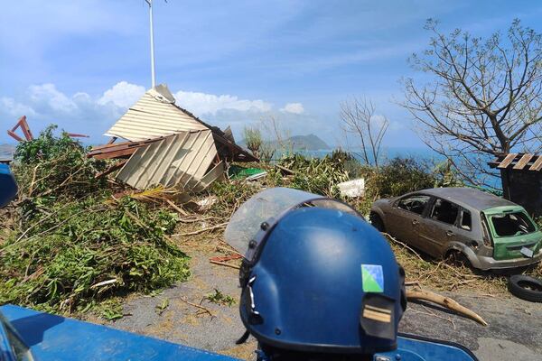 This photo provided on Monday Dec.16, 2024 by the Gendarmerie Nationale, shows a member of the Gendarmerie Nationale watching debris Sunday, Dec. 15, 2024 in Mayotte as France rushed rescue teams and supplies to its largely poor overseas department in the Indian Ocean that has suffered widespread destruction. (Gendarmerie Nationale via AP)