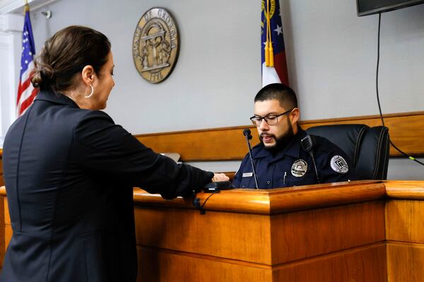 Prosecutor Sheila Ross speaks to the University of Georgia Police Rafael Sayan during the second day of the trial of Jose Ibarra at Athens-Clarke County Superior Court on Monday, Nov. 18, 2024, in Athens, Ga. (Miguel Martinez/Atlanta Journal-Constitution via AP, Pool)