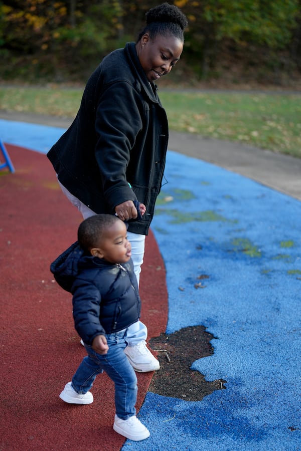 Anika Chillis, left, spends time with her son, Makhi, 2, at a playground Monday, Dec. 2, 2024, in Memphis, Tenn. (AP Photo/George Walker IV)