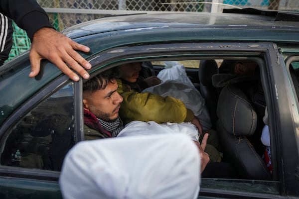 Mourners carry the bodies of their relatives killed in the Israeli bombardment of the Gaza Strip, during their funerl at Al-Aqsa Martyrs Hospital in Deir al-Balah, Sunday, Jan. 5, 2025. (AP Photo/Abdel Kareem Hana)