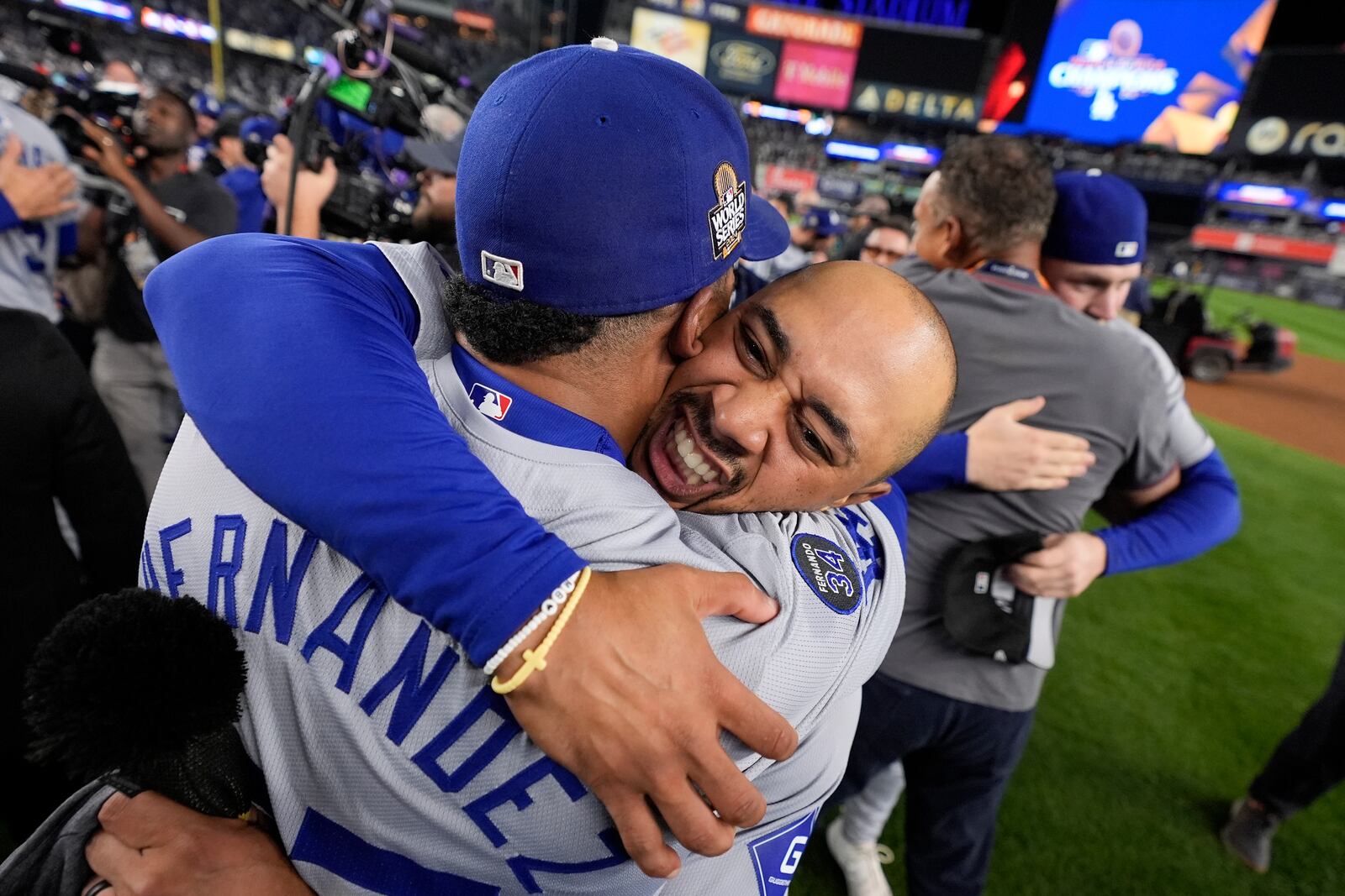 Los Angeles Dodgers' Freddie Freeman and Teoscar Hernández celebrate their win against the New York Yankees in Game 5 to win the baseball World Series, Wednesday, Oct. 30, 2024, in New York. (AP Photo/Ashley Landis)