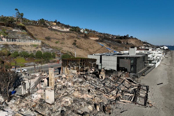 An aerial view shows the devastation from the Palisades Fire on beachfront homes Wednesday, Jan. 15, 2025 in Malibu, Calif. (AP Photo/Jae C. Hong)