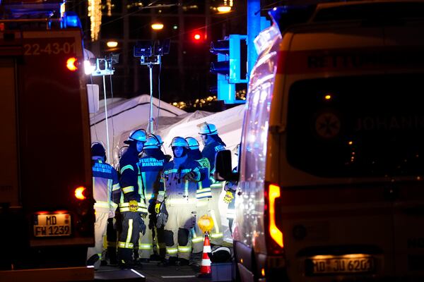 Emergency services work in a cordoned-off area near a Christmas Market, after a car drove into a crowd in Magdeburg, Germany, Friday, Dec. 20, 2024. (AP Photo/Ebrahim Noroozi)