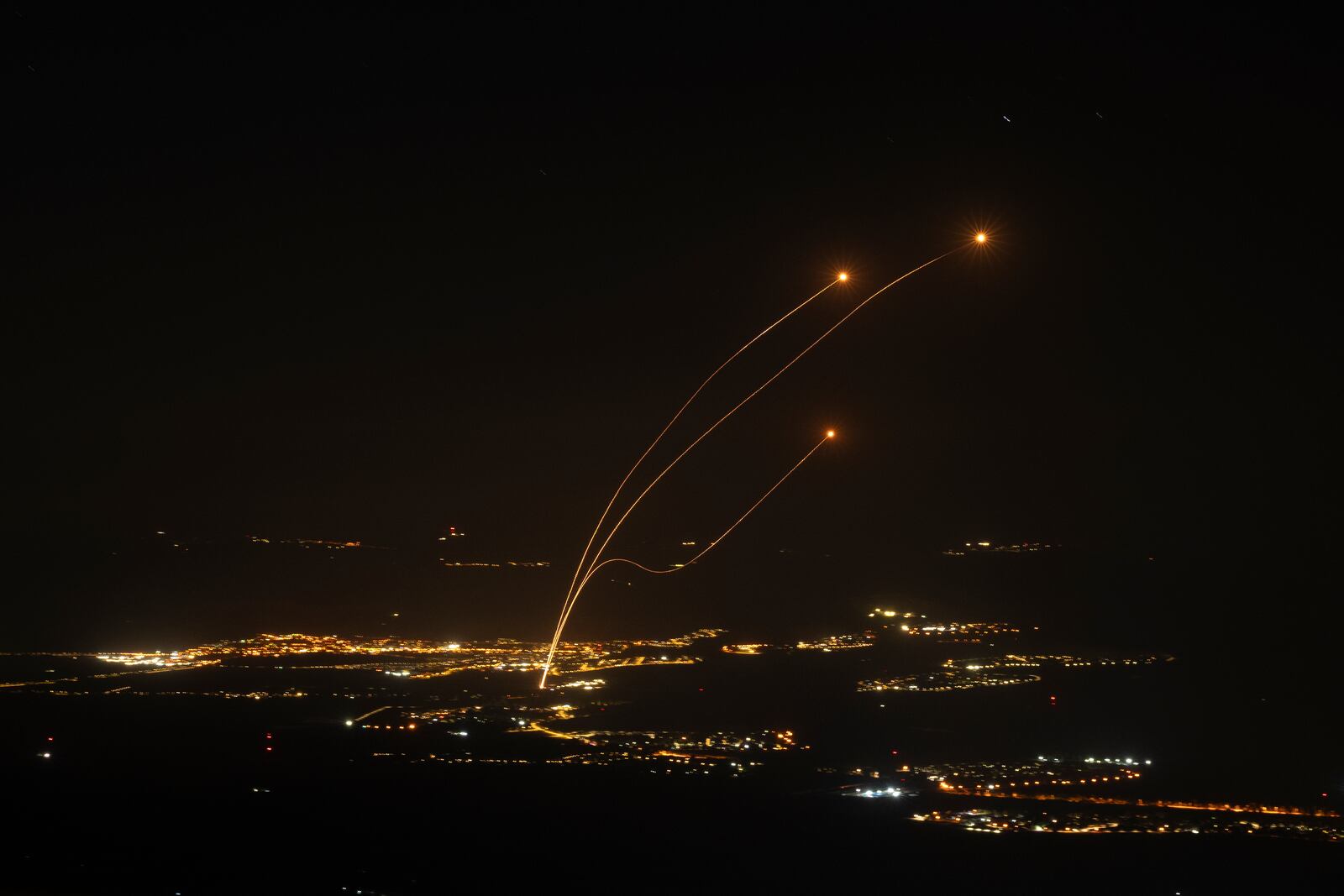 The Israeli Iron Dome air defense system fires to intercept rockets launched from Lebanon, near Kiryat Shmona, as seen from the Israeli-annexed Golan Heights, Saturday, Oct. 26, 2024. (AP Photo/Leo Correa)