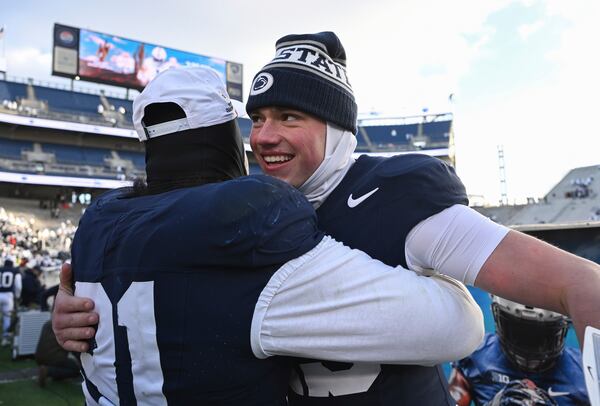 Penn State quarterback Drew Allar, right, celebrates with Dvon J-Thomas, left, following their win over SMU during the first round of the College Football Playoff, Saturday, Dec. 21, 2024, in State College, Pa. (AP Photo/Barry Reeger)