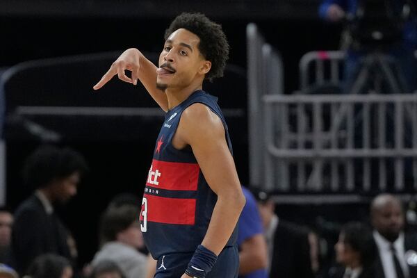 Washington Wizards guard Jordan Poole gestures after making a 3-point basket during the first half of an NBA basketball game against the Golden State Warriors in San Francisco, Saturday, Jan. 18, 2025. (AP Photo/Jeff Chiu)