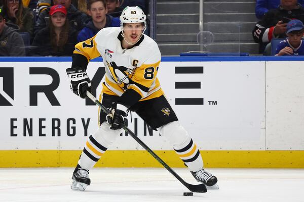 Pittsburgh Penguins center Sidney Crosby (87) controls the puck during the second period of an NHL hockey game against the Buffalo Sabres Friday, Jan. 17, 2025, in Buffalo, N.Y. (AP Photo/Jeffrey T. Barnes)