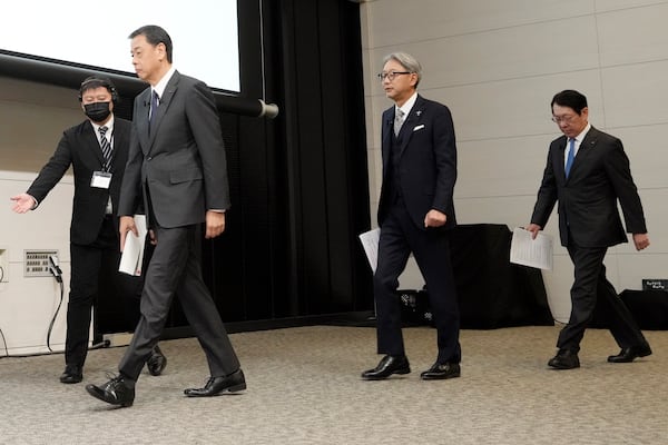 Nissan Chief Executive Makoto Uchida, left, and Honda Chief Executive Toshihiro Mibe, center, and Takao Kato CEO of Mitsubishi Motors, right, arrive to attend a joint news conference Monday, Dec. 23, 2024, in Tokyo, Japan. (AP Photo/Eugene Hoshiko)