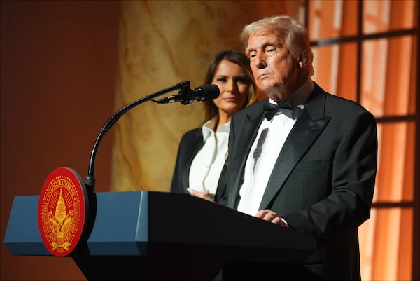 President-elect Donald Trump speaks at a dinner at the Building Museum, Sunday, Jan. 19, 2025, in Washington, as Melania Trump listens. (AP Photo/Evan Vucci)