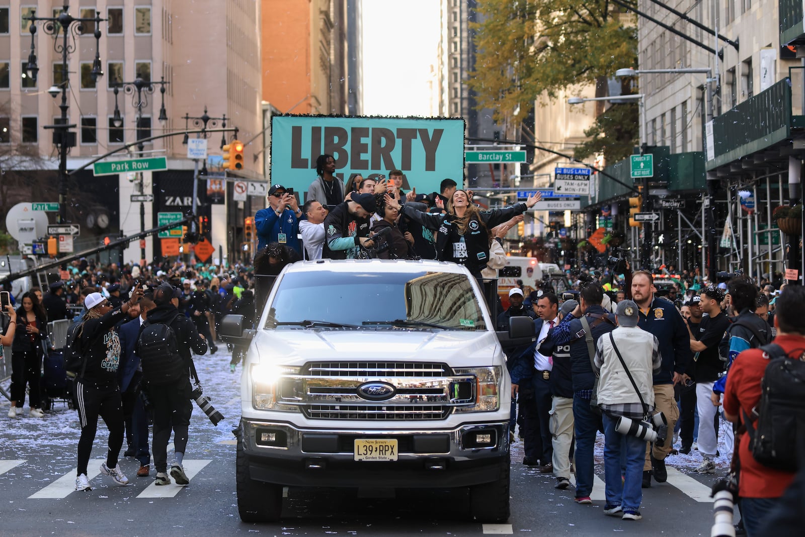 New York Liberty guard Sabrina Ionescu, right, reacts while riding down the Canyon of Heroes on Broadway during a parade celebrating the team's WNBA basketball championship, Thursday, Oct. 24, 2024, in New York. (AP Photo/Yuki Iwamura)