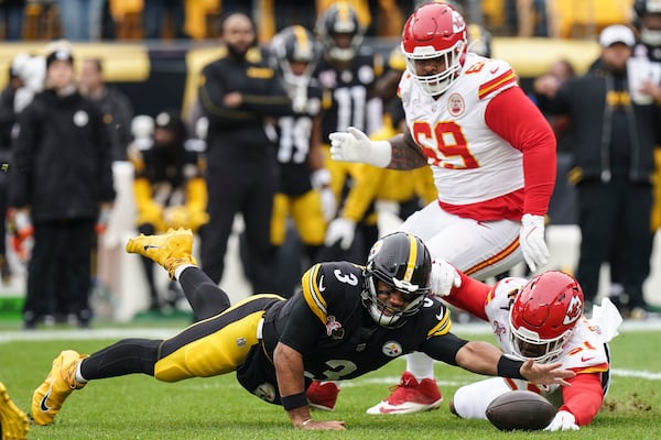 Pittsburgh Steelers quarterback Russell Wilson (3) reaches to recover his own fumble against Kansas City Chiefs defensive end Mike Danna (51) during the first half of an NFL football game, Wednesday, Dec. 25, 2024, in Pittsburgh. (AP Photo/Matt Freed)