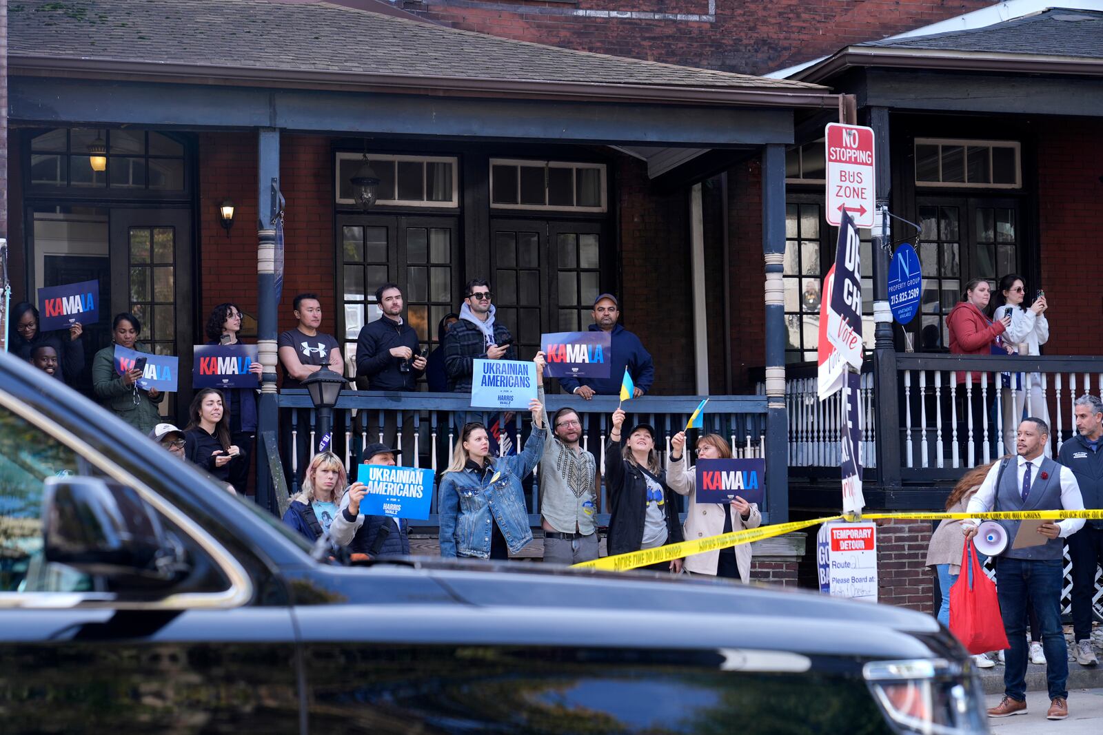 Supporters hold signs outside Philly Cuts barbershop as Democratic presidential nominee Vice President Kamala Harris visits during a campaign stop, Sunday, Oct. 27, 2024, in Philadelphia. (AP Photo/Susan Walsh)