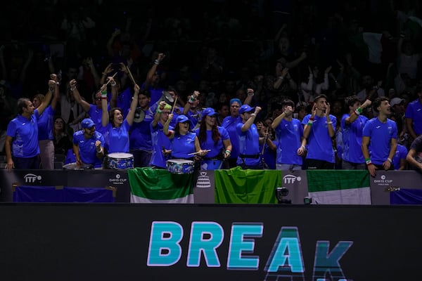 Supporters of Italy cheer during the match between Italy's Matteo Berrettini and Australia's Thanasi Kokkinakis during the Davis Cup semifinal at the Martin Carpena Sports Hall in Malaga, southern Spain, on Saturday, Nov. 23, 2024. (AP Photo/Manu Fernandez)