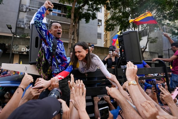 Opposition leader Maria Corina Machado greets supporters during a protest against Venezuelan President Nicolas Maduro the day before his inauguration for a third term in Caracas, Venezuela, Thursday, Jan. 9, 2025. (AP Photo/Matias Delacroix)