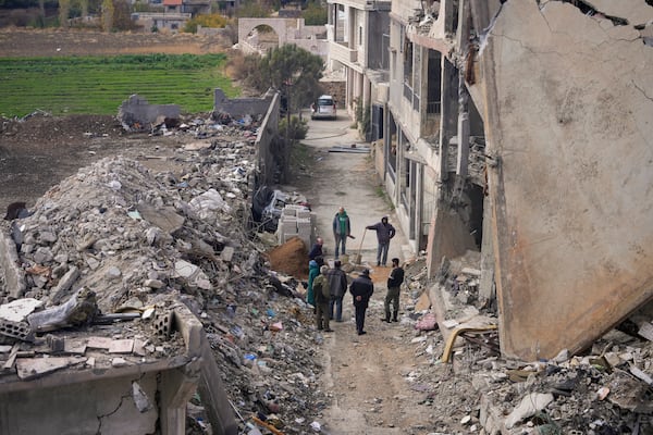 Residents start rebuilding their houses damaged in Israeli airstrikes, in Baalbek, eastern Lebanon, Thursday, Nov. 28, 2024. (AP Photo/Hassan Ammar)