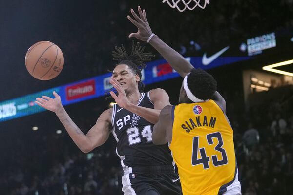 San Antonio Spurs guard Devin Vassell (24) looks toward the ball while being defended by Indiana Pacers forward Pascal Siakam (43) during the second half of a Paris Games 2025 NBA basketball game in Paris, Thursday, Jan. 23, 2025. (AP Photo/Thibault Camus)