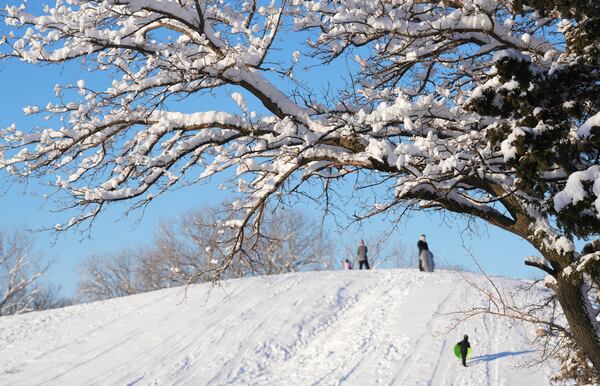 Early morning sledders enjoy the hill at Sedgwick County Park in Wichita, Kan. on Friday, Jan. 10, 2025. (Jaime Green/The Wichita Eagle via AP)