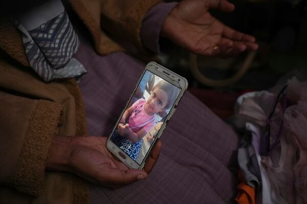 Areej al Qadi shows shows a picture of her daughter Laila at her tent in a refugee camp in Deir al-Balah, Gaza Strip, Thursday Nov. 21, 2024. Seven-year-old Hamza, his five-year-old brother Abdelaziz, and his four-year-old sister Laila Hassan were among 9 people killed by an Israeli strike in Khan Younis on Wednesday. Palestinian health officials say the death toll in the Gaza Strip from the 13-month-old war between Israel and Hamas has surpassed 44,000. (AP Photo/Abdel Kareem Hana)