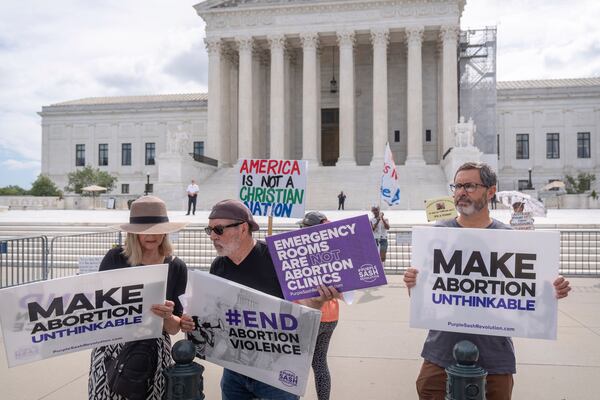 FILE - Katie Mahoney, left, and Rev. Patrick Mahoney, chief strategy officer for Stanton Healthcare, an Idaho-based pregnancy center that does not provide abortions, read the text of a Supreme Court decision outside the Supreme Court on Thursday, June 27, 2024, in Washington. (AP Photo/Mark Schiefelbein, File)