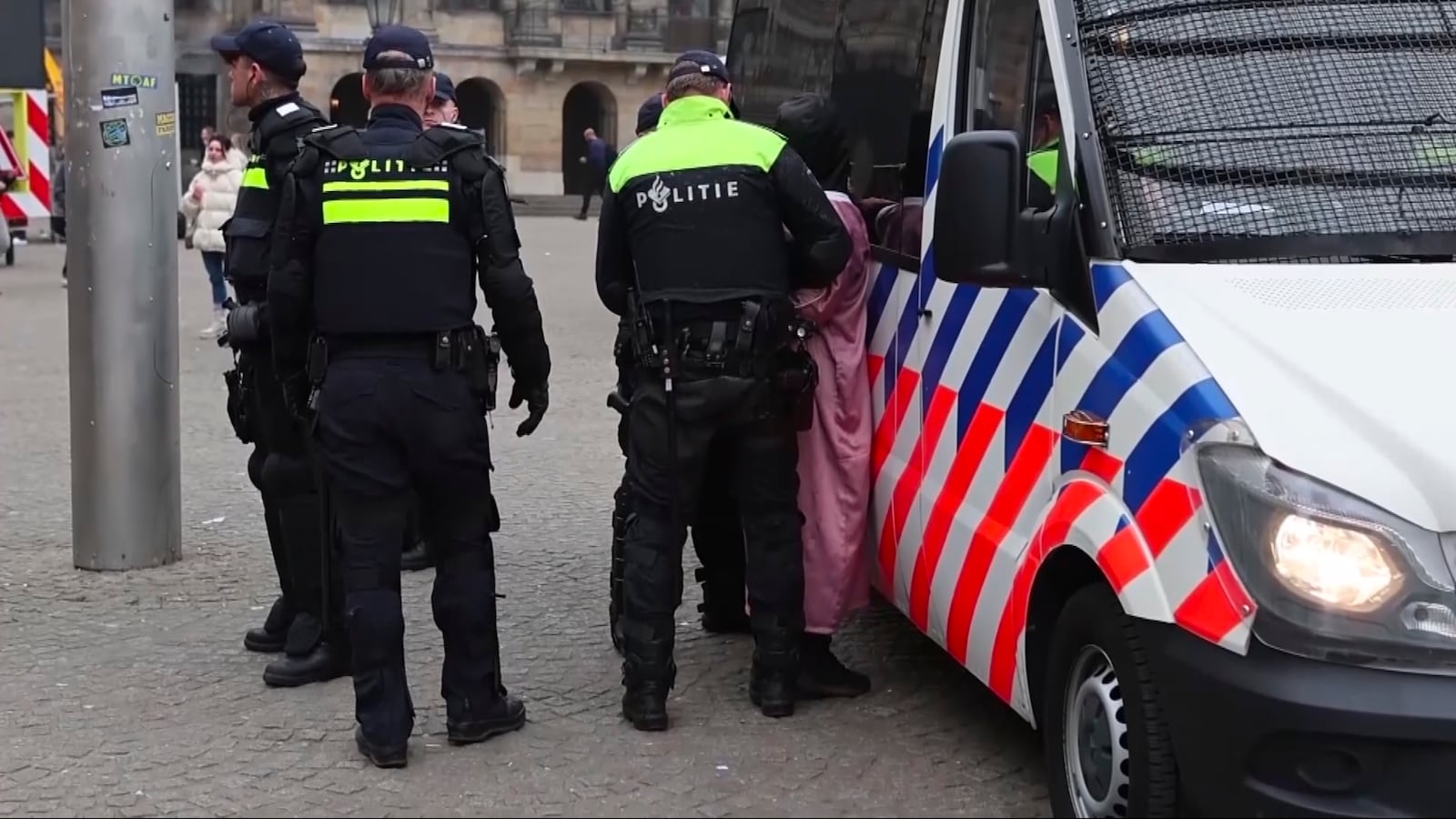 In this image taken from video, police detain a person next to the place where Maccabi Tel Aviv supporters gather ahead of the Europa League soccer match between their team and Ajax, in Amsterdam, the Netherlands, Thursday, Nov. 7, 2024. (AP Photo InterVision)