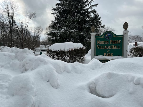 Snow covers the sign for the North Perry Village Hall in North Perry, Ohio on Tuesday, Dec. 3, 2024. (AP Photo/Patrick Aftoora-Orsagos)