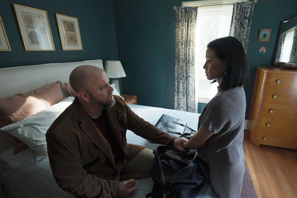 This image released by Neon shows Chris Sullivan, left, and Lucy Liu in a scene from "Presence." (Neon via AP)