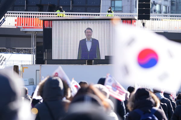 A screen displays footage of impeached South Korean President Yoon Suk Yeol as supporters stage a rally to oppose his impeachment near the presidential residence in Seoul, South Korea, Wednesday, Jan. 15, 2025. (AP Photo/Lee Jin-man)