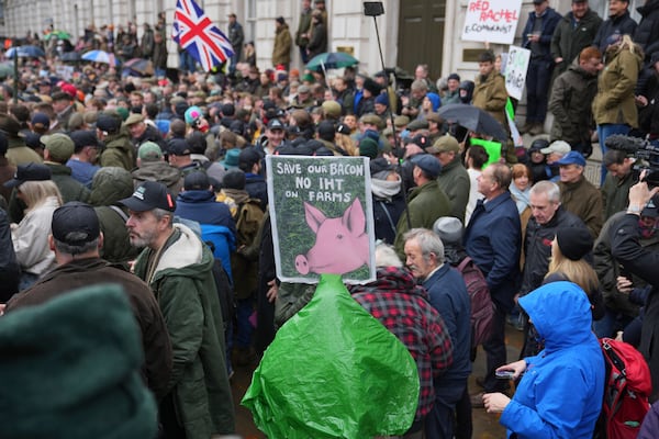 The National Farmers' Union members attend a protest against the planned changes to tax rules, in London, Tuesday, Nov. 19, 2024. (AP Photo/Kin Cheung)