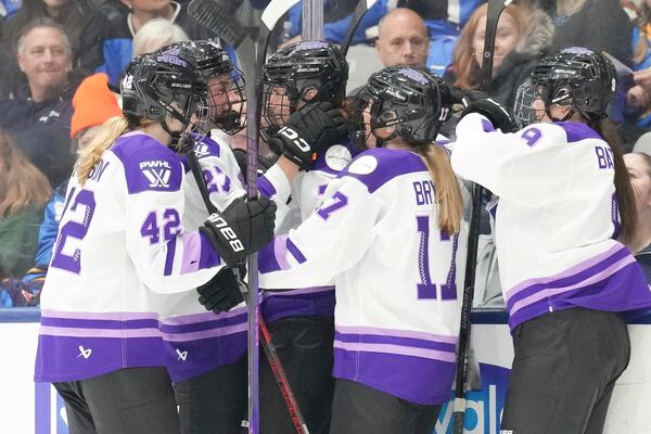 Minnesota Frost's Britta Curl, centre, celebrates with teammates after scoring against Toronto Sceptres during third period PWHL hockey action on Saturday, Dec. 7, 2024. (Chris Young/The Canadian Press via AP)