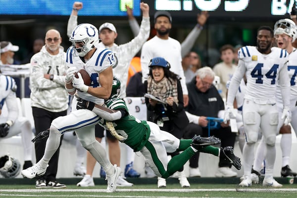 Indianapolis Colts wide receiver Alec Pierce (14) makes a catch against New York Jets safety Jalen Mills (35) for a first down during the fourth quarter of an NFL football game, Sunday, Nov. 17, 2024, in East Rutherford, N.J. (AP Photo/Adam Hunger)