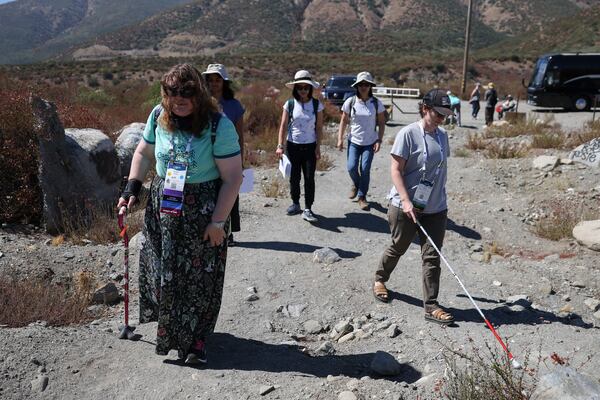 Attendees walk during an accessible field trip to the San Andreas Fault organized by the International Association of Geoscience Diversity Thursday, Sept. 26, 2024, in San Bernadino, Calif. (AP Photo/Ryan Sun)