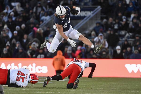 FILE - Penn State tight end Tyler Warren (44) hurdles Maryland defensive back Kevis Thomas (25) during the second quarter of an NCAA college football game, Saturday, Nov. 30, 2024, in State College, Pa. (AP Photo/Barry Reeger, File)