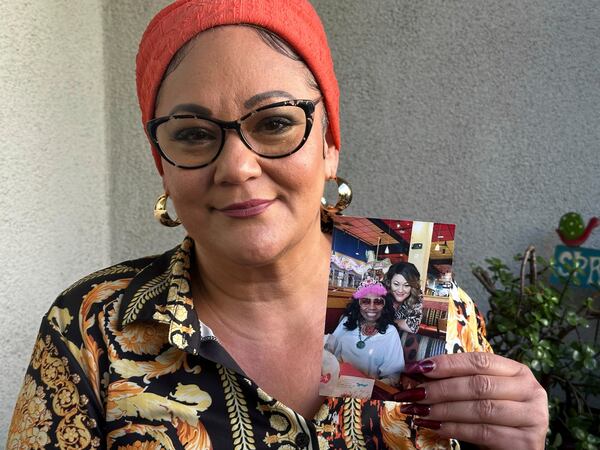 Dalyce Kelley holds up a picture of her grandmother, 95-year-old Dalyce Curry, on Tuesday, Jan. 14, 2025, days after Curry died in the California wildfires. (AP Photo/Eugene Garcia)