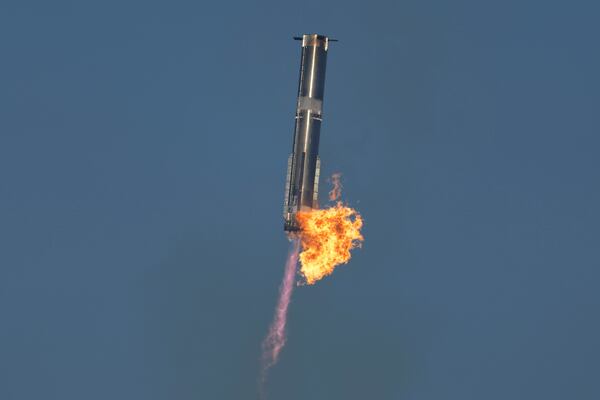 SpaceX's mega rocket Starship booster returns to the launch pad during a test flight from Starbase in Boca Chica, Texas, Thursday, Jan. 16, 2025. (AP Photo/Eric Gay)