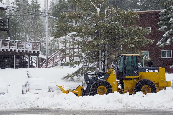 Snow is cleared from a road by tractor Thursday, Nov. 21, 2024, at Donner Ski Ranch near Truckee, Calif. (AP Photo/Brooke Hess-Homeier)