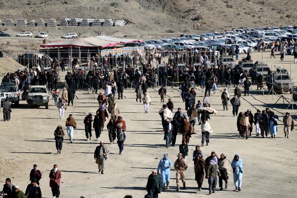 People attend the funeral prayer of Khalil Haqqani, the minister for refugees and repatriation, during his funeral procession in eastern Paktia province, Afghanistan, Thursday, Dec. 12, 2024. (AP Photo/Saifullah Zahir)