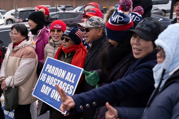 Supporters of President Donald stand with their flags in support of people convicted for their part in the Jan. 6 riot at the U.S. Capitol at the DC Central Detention Facility in Washington, Tuesday, Jan. 21, 2025. (AP Photo/Jose Luis Magana)