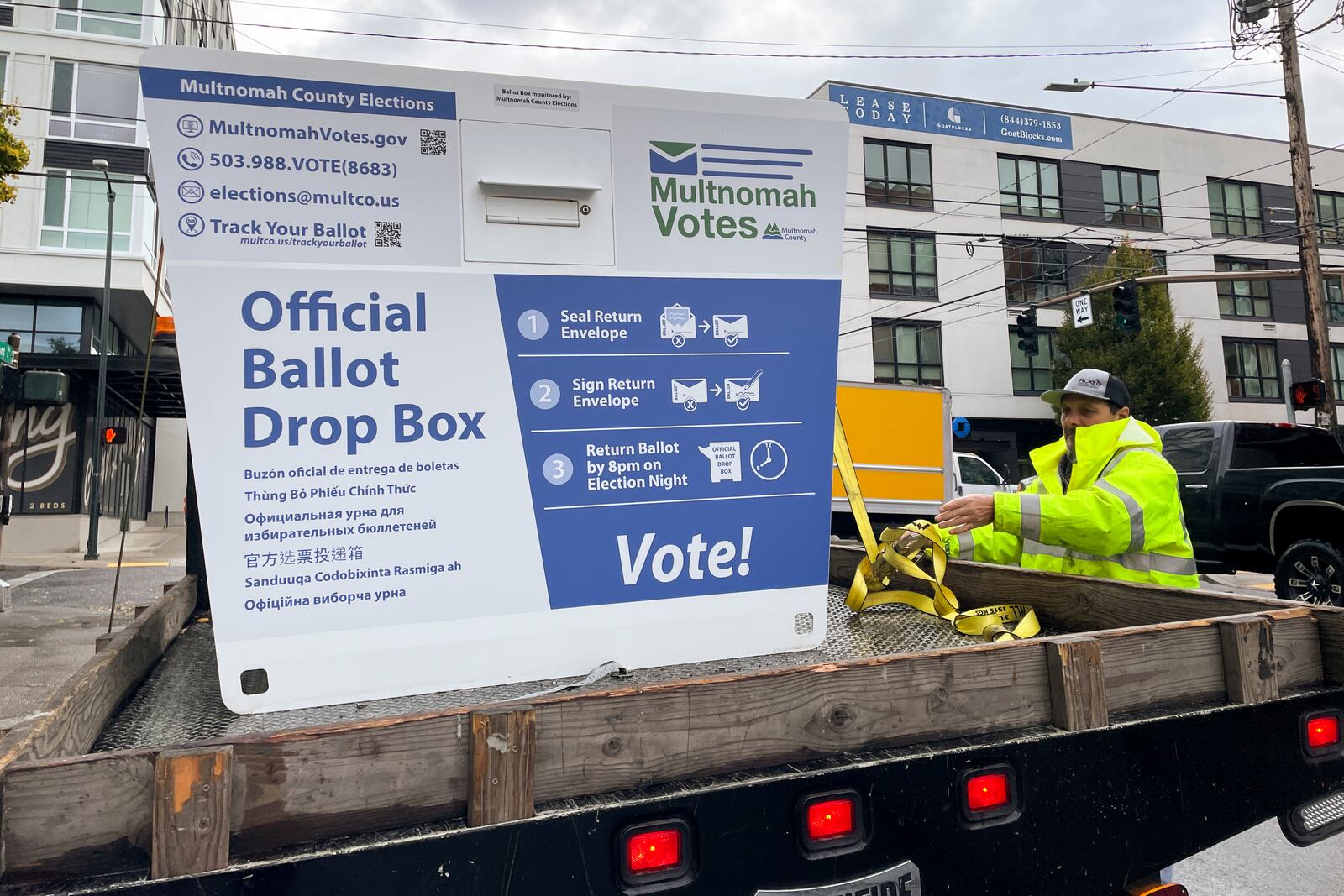 A replacement ballot drop box is unloaded on Monday, Oct. 28, 2024, in Portland, Ore. The Portland Police Bureau reported that officers and firefighters responded to a fire in one ballot drop box on Monday morning. (AP Photo/Claire Rush)