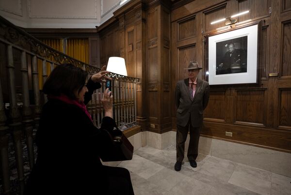 Guests invited to an unveiling ceremony take their photo in front of The Roaring Lion, a 1941 portrait of Winston Churchill taken by Yousuf Karsh, Friday, Nov. 15, 2024 at the Fairmont Chateau Laurier hotel in Ottawa, Ontario. The portrait was unveiled after being stolen and returned. (Adrian Wyld/The Canadian Press via AP)