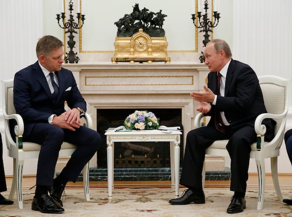 FILE - Russian President Vladimir Putin, right, speaks to Slovak Prime Minister Robert Fico during their meeting in the Kremlin in Moscow, Russia, Thursday, Aug. 25, 2016. (AP Photo/Alexander Zemlianichenko, pool, File)