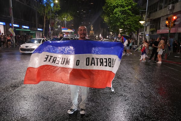 Supporters of the Broad Front (Frente Amplio) celebrate the victory of candidate Yamandú Orsi in the presidential run-off election in Montevideo, Uruguay, Sunday, Nov. 24, 2024. (AP Photo/Matilde Campodonico)