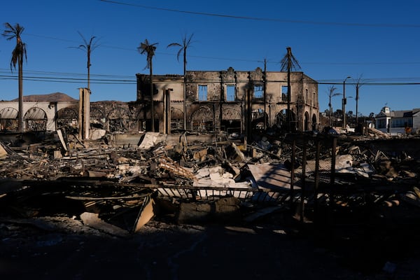 Burned businesses are left behind by the Palisades Fire in the Pacific Palisades neighborhood of Los Angeles, Tuesday, Jan. 14, 2025. (AP Photo/Carolyn Kaster)