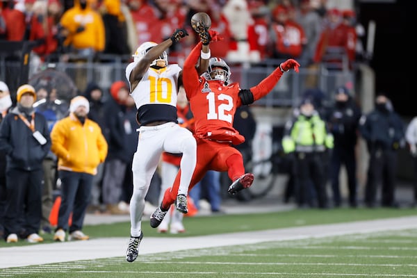 Ohio State defensive back Bryce West, right, breaks up a pass intended for Tennessee receiver Mike Matthews during the second half in the first round of the College Football Playoff, Saturday, Dec. 21, 2024, in Columbus, Ohio. (AP Photo/Jay LaPrete)