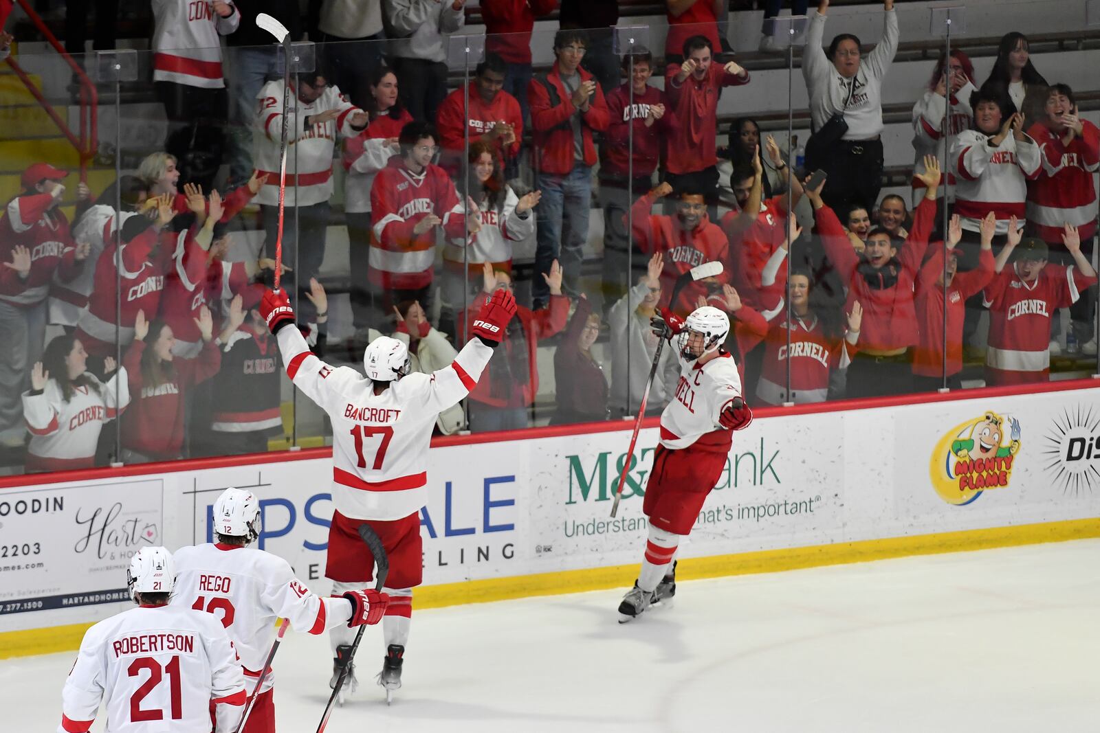 FILE - Cornell forward Kyle Penney, right, celebrates with forward Dalton Bancroft (17) after scoring during the third period of an NCAA hockey game against North Dakota on Nov. 2, 2024 in Ithaca, N.Y. (AP Photo/Adrian Kraus, file)