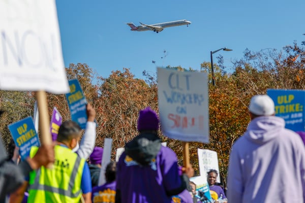 An airplane arrives at Charlotte Douglas International Airport as airport workers strike in front of the Charlotte Douglas International Airport in Charlotte, N.C., Monday, Nov. 25, 2024. (AP Photo/Nell Redmond)