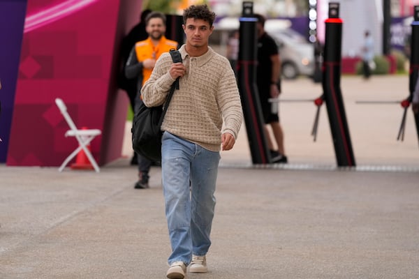 McLaren driver Lando Norris of Britain walks through paddock as he arrives at the Lusail International Circuit in Lusail, Qatar, ahead of the Qatar Grand Prix, Thursday, Nov. 28, 2024. (AP Photo/Darko Bandic)