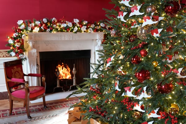 The Red Room of the White House in Washington, is decorated for the holidays, Monday, Dec. 2, 2024. (AP Photo/Susan Walsh)