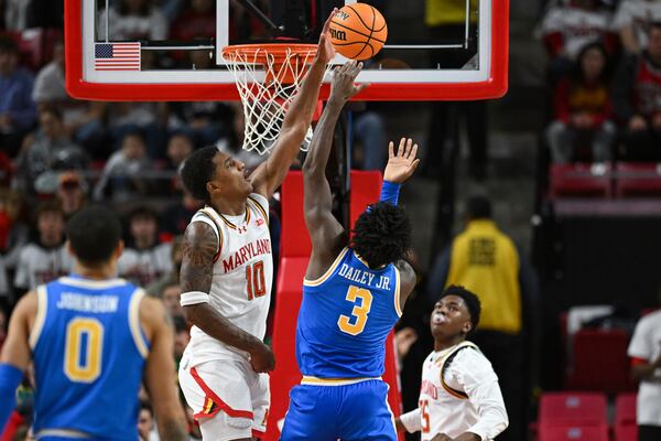 Maryland forward Julian Reese (10) blocks UCLA guard Eric Dailey Jr. (3) shot during the second half of an NCAA college basketball game, Friday, Jan. 10, 2025, in College Park, Md. (AP Photo/Terrance Williams)