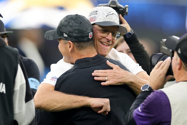 Los Angeles Chargers head coach Jim Harbaugh, right, hugs his brother Baltimore Ravens Head Coach John Harbaugh before an NFL football game Monday, Nov. 25, 2024, in Inglewood, Calif. (AP Photo/Ryan Sun)